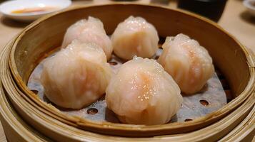 Steamed Shrimp Dumplings in Bamboo Steamer Close Up. A delectable image of freshly steamed shrimp dumplings, showcasing their translucent skin and vibrant filling. photo