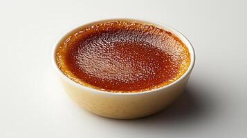 A cup of caramel on a white surface photo