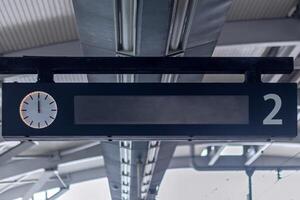 LED panel display with analog clock in the train station. Train Schedule Display. photo