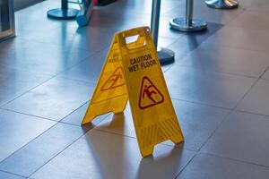 Caution wet floor sign in the public area. Wet floor warning and caution sign. photo