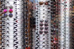 View of various kinds of sunglasses and fashion eyewear on display in an eyewear store photo