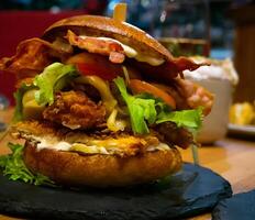 Close-up of a Pulled Pork and Bacon Burger on a table photo