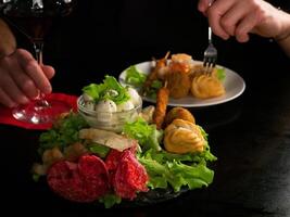 Culinary Encounter Savoring Red Wine with a Diverse Selection of Appetizers photo