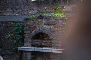 Rustic Stone Structure with Ivy and Arched Opening in Riga Old Town photo
