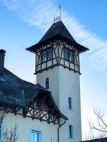 Facade of a historical building with a tower in the evening twilight photo