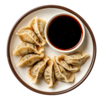 Traditional steamed dumplings arranged in circle on white plate with dark soy sauce, isolated on a transparent background png