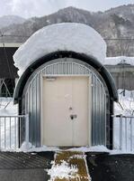 Locked door of a snow covered small cabin in the mountains photo