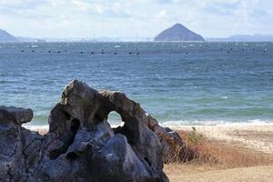 Coastal scene with waves arriving at the beach in Naoshima, Japan photo