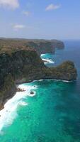 Aerial view of scenic cliffs and turquoise water on Nusa Penida Island, Bali, Indonesia. Stunning landscape ideal for travel, nature, and tropical paradise themes. video