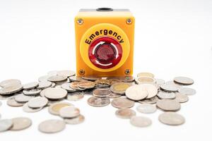 Emergency Economy Concept. Financial Crisis Warning with Stop Button and Thai Coins. Emergency stop button surrounded by scattered coins on white background. photo