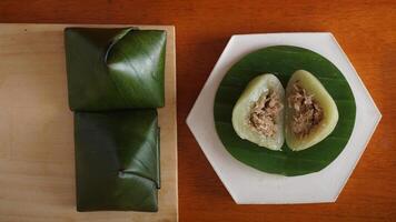 Kue Bugis, popular traditional Indonesian snack dessert made from glutinous rice flour on wooden platter photo