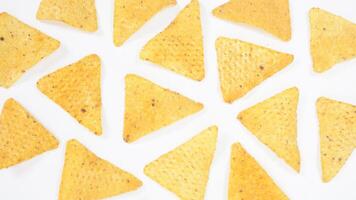 Yellow nachos chips pattern isolated on white background photo