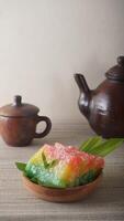 Sweet traditional Indonesian snack with chewy texture called Ongol-ongol on wooden plate photo