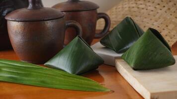 Traditional Indonesian snack dessert wrap in green leaves called Kue Bugis photo