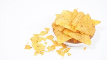 Tortilla chips on small plate whit crumbs isolated on white background photo