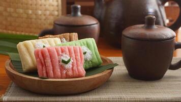 Gethuk, a traditional Indonesian snack made from steamed and mashed cassava with sugar in various colors with grated coconut topping photo