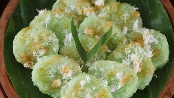 Kue Lupis, delicious traditional Indonesia rice cake snack with grated coconut and palm sugar syrup photo