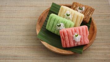 Gethuk, a colorful traditional Indonesian snack made from steamed and mashed cassava with grated coconut topping photo