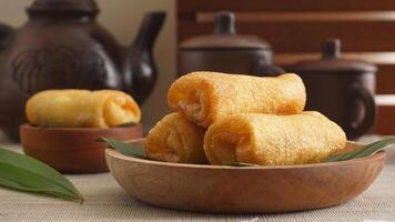 Selective focus of Lumpia, a savory traditional Indonesian deep-fried spring roll snack filled with vegetables photo