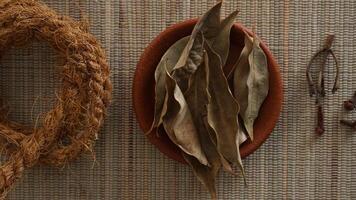 Top view of dried pala leaves or leaves of nutmeg tree on plate photo