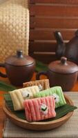 Gethuk, a traditional Indonesian sweet snack made from steamed and mashed cassava in various colors with grated coconut topping photo