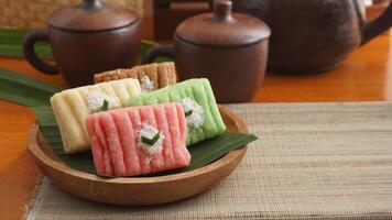 Gethuk, a delicious traditional Indonesian snack made from steamed and mashed cassava in various colors with grated coconut topping photo