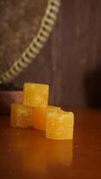 Stack of yellow rock sugar isolated on rustic background photo