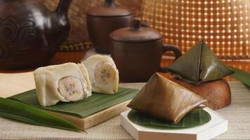 Selective focus of Nogosari, a traditional Indonesian steamed snack made from rice flour, coconut milk, and banana, wrapped in banana leaves photo