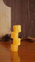 Stack of rock sugar isolated against wooden texture background photo