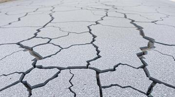 Cracked asphalt road surface showing damage and texture. photo