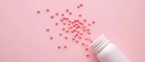 Pink heart shaped medication scattered from a white bottle photo