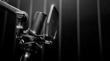 Microphone in studio. Professional studio microphone with a pop filter is suspended boom arm and studio lights. Set up mic for podcast voice over or recording high quality sound audio in a control photo