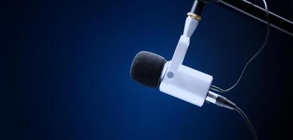 Microphone in studio. Professional studio microphone with a pop filter is suspended boom arm and studio lights. Set up mic for podcast voice over or recording high quality sound audio in a controlled. photo