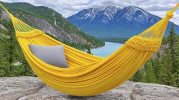 Yellow Hammock Overlooking Mountain Lake and Snowy Peaks photo
