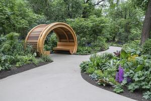 Wooden Arbor in a Lush Garden with Winding Pathways photo