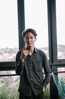 Young man points up in modern setting, expressing an idea or concept photo