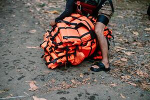 Man preparing safety equipment for rafting adventure experience photo
