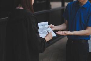 A man handing a woman a document photo