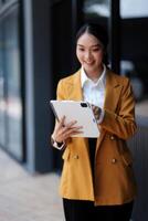Asian business woman using tablet computer photo