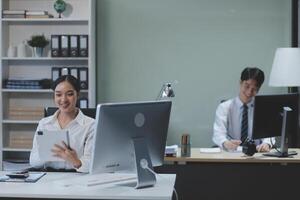 A woman in an office is using a tablet photo