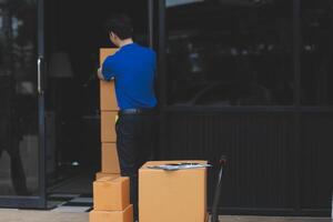 A man is moving boxes into a building photo