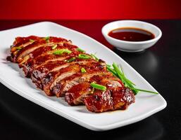 Crispy Peking Duck Slices Displayed on a Rectangular White Platter photo