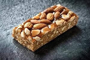 Protein bar with almonds and caramel resting on dark background photo