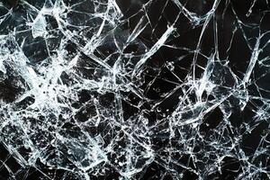 Broken glass texture creating abstract white lines on black background photo