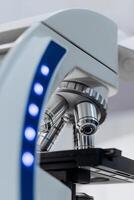 Science white microscope equipment in biology chemical laboratory. Scientific experiment Microscope on Lab table microbiology equipment. Chemistry objects on lab background. Medicine, ads, vertical photo