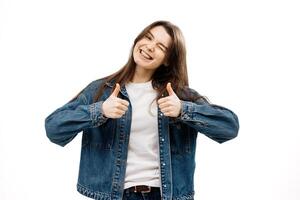 Well done, very well done. The young woman gives a thumbs-up and a wink, telling you yes, approving something good and recommending it against a white background photo