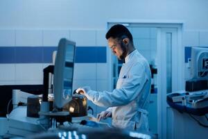 Modern Medical Research Laboratory. Man Scientists Working, Using Computer, Analyzing Test. Advanced Scientific Pharmaceutical Lab for Medicine, Biotechnology Development. Evening Time. photo