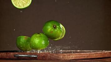 Lime slices fall on a wooden table. Filmed on a high-speed camera at 1000 fps. High quality FullHD footage video