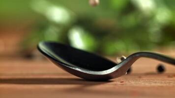 Peppercorns fall on the table. Filmed on a high-speed camera at 1000 fps. High quality FullHD footage video