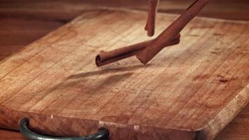Cinnamon sticks fall on the table. Filmed on a high-speed camera at 1000 fps. High quality FullHD footage video